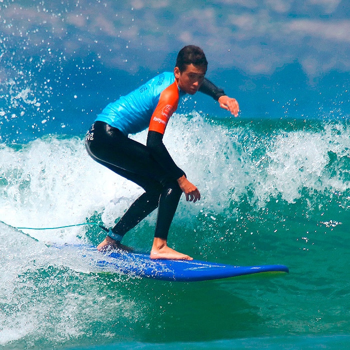 instructor surfeando en la playa de loredo